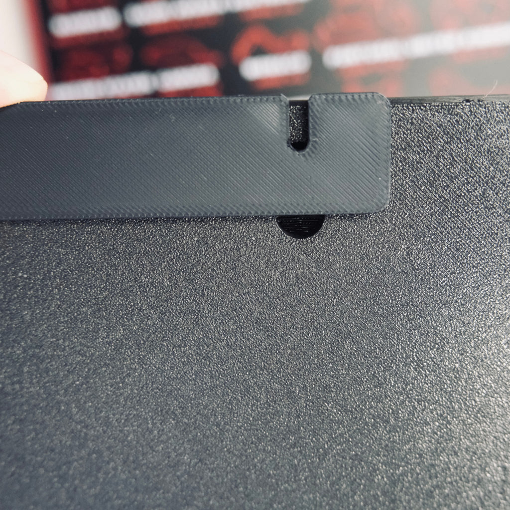 Back of the race calendar showing the hidden keyhole slot for wall mounting