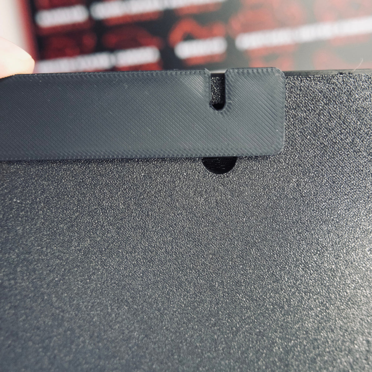 Back of the race calendar showing the hidden keyhole slot for wall mounting