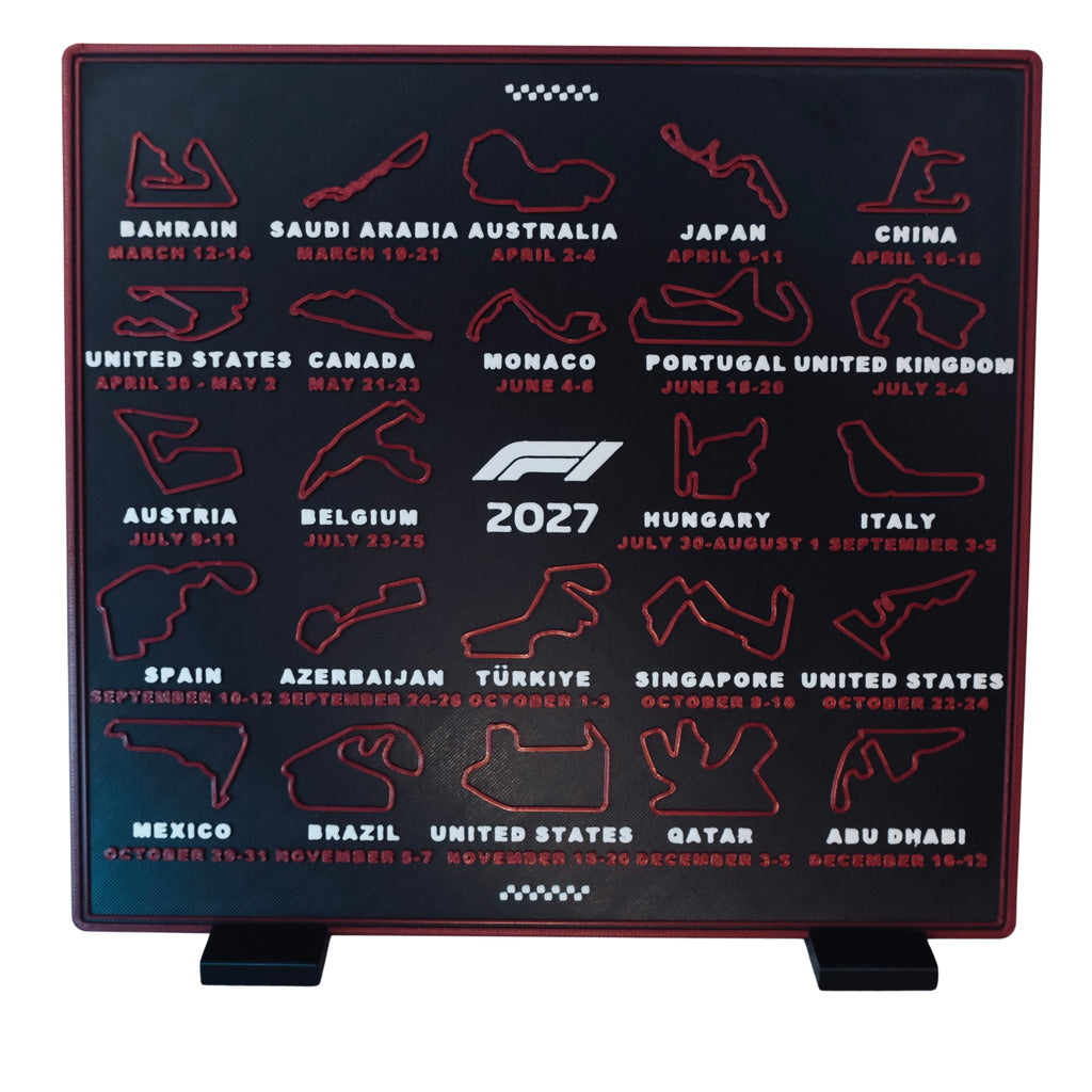 3D printed 2027 race calendar by RU3D – red circuit maps on a charcoal display, standing on its two stand feet