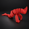 Articulated Red Bluster with flexible segmented body displayed on a dark charcoal studio background.