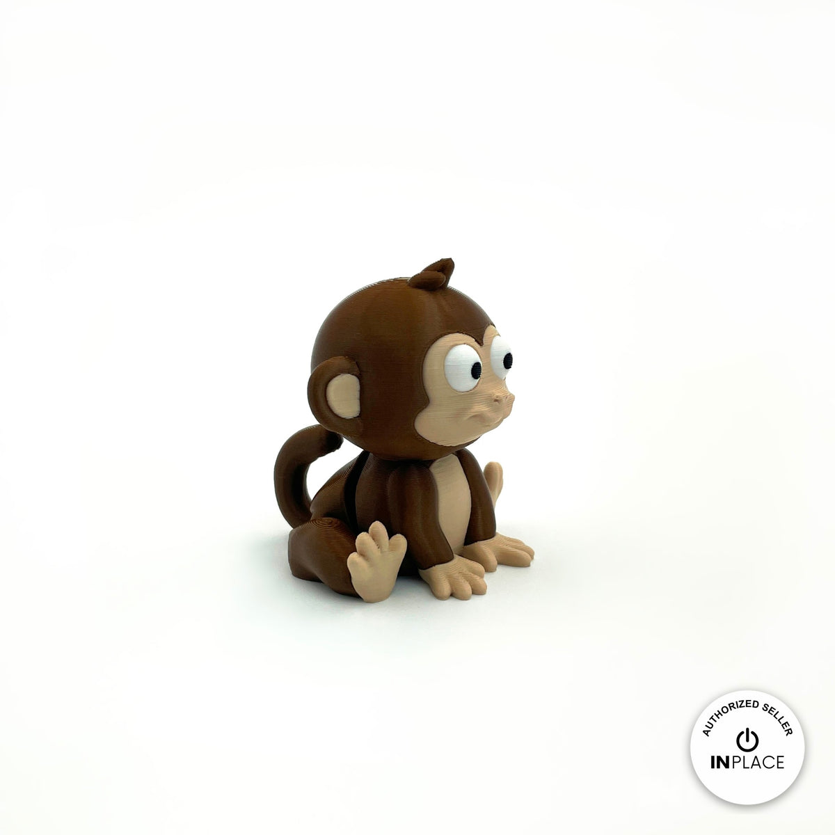Cute baby monkey keychain, 3D printed by RU3D – sitting side view facing right. Dark brown with tan face.