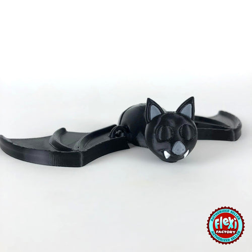 Cute bat keychain, 3D printed by RU3D – dark eyes version wings spread. Black with grey ears and white fangs.