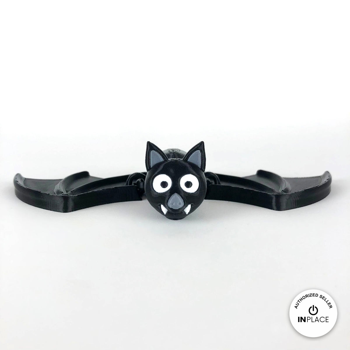 Cute bat keychain, 3D printed by RU3D – front view wings spread. Black with grey ears and white fangs.
