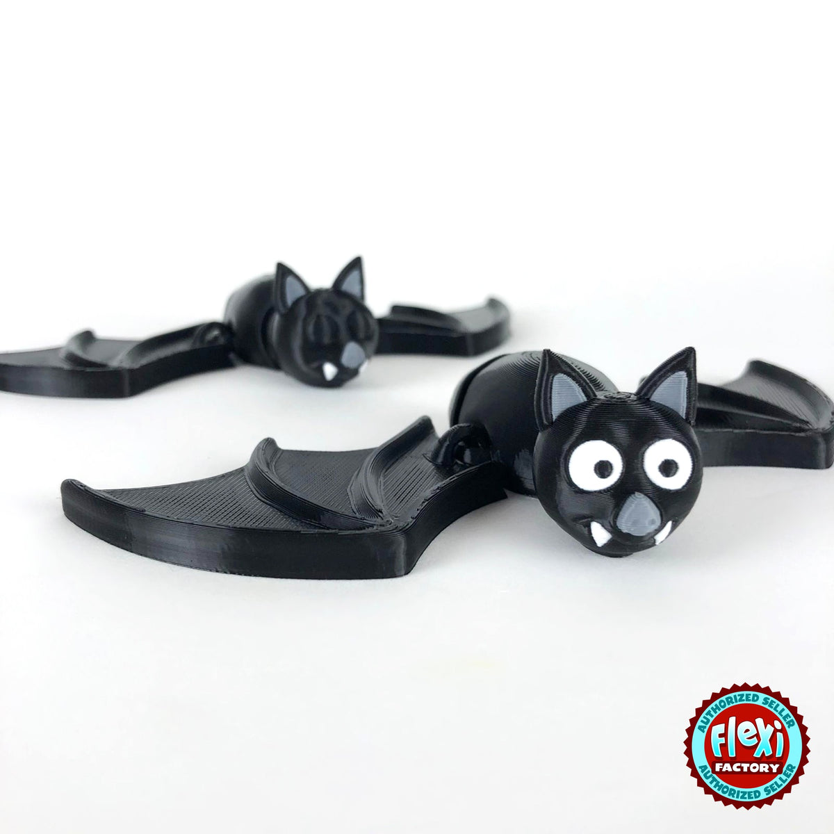 Cute bat keychain, 3D printed by RU3D – pair of bats. Black with grey ears and white fangs.