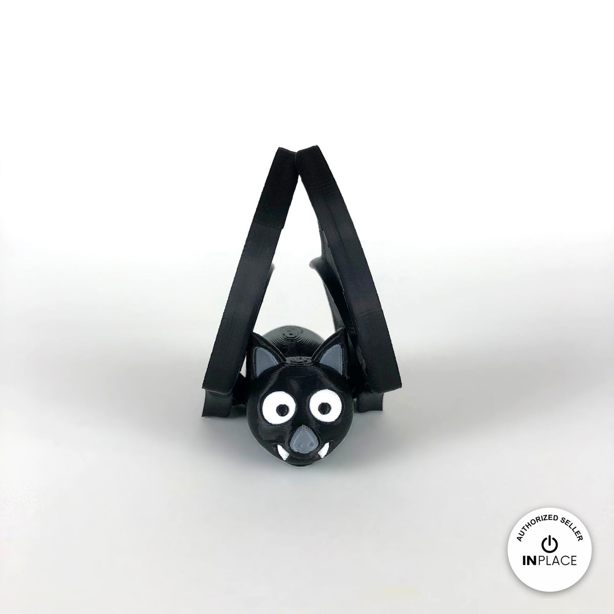 Cute bat keychain, 3D printed by RU3D – wings folded up front view. Black with grey ears and white fangs.