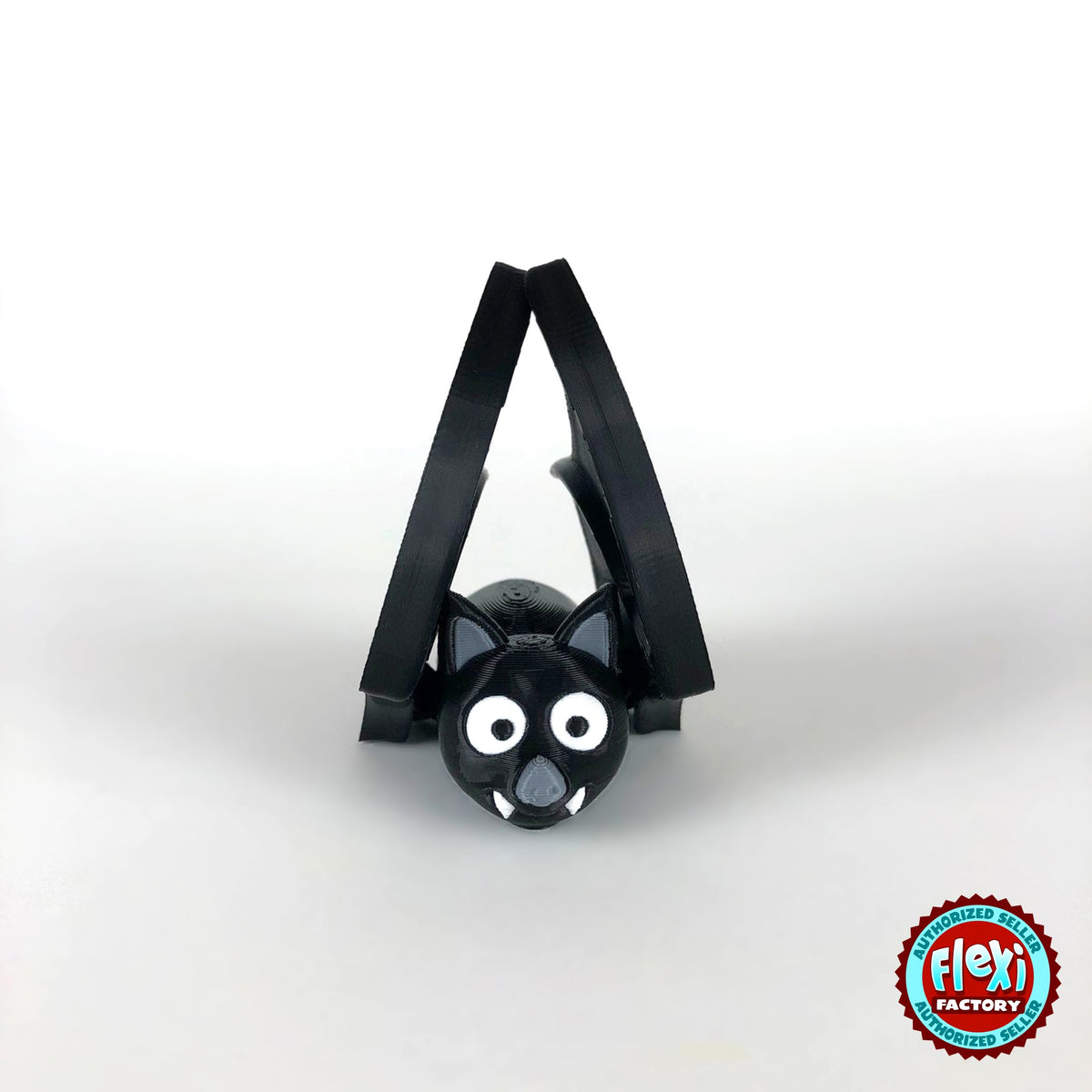 Cute bat keychain, 3D printed by RU3D – wings folded up front view. Black with grey ears and white fangs.