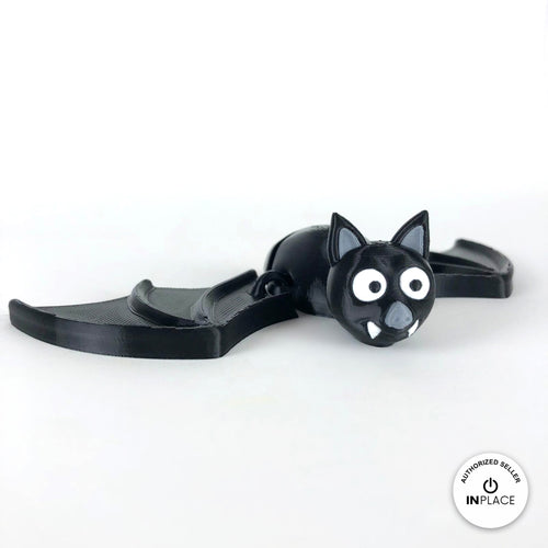 Cute bat keychain, 3D printed by RU3D – wings spread three quarter view. Black with grey ears and white fangs.