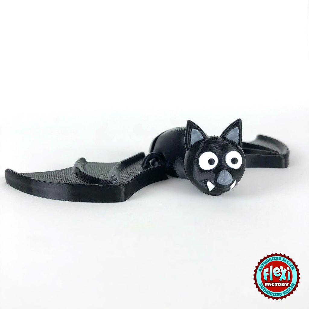Cute bat keychain, 3D printed by RU3D – wings spread three quarter view. Black with grey ears and white fangs.