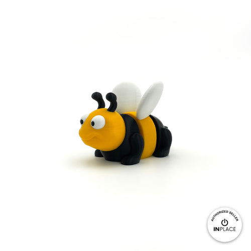 Cute bee keychain, 3D printed by RU3D – three quarter view facing left. Yellow and black with white wings.