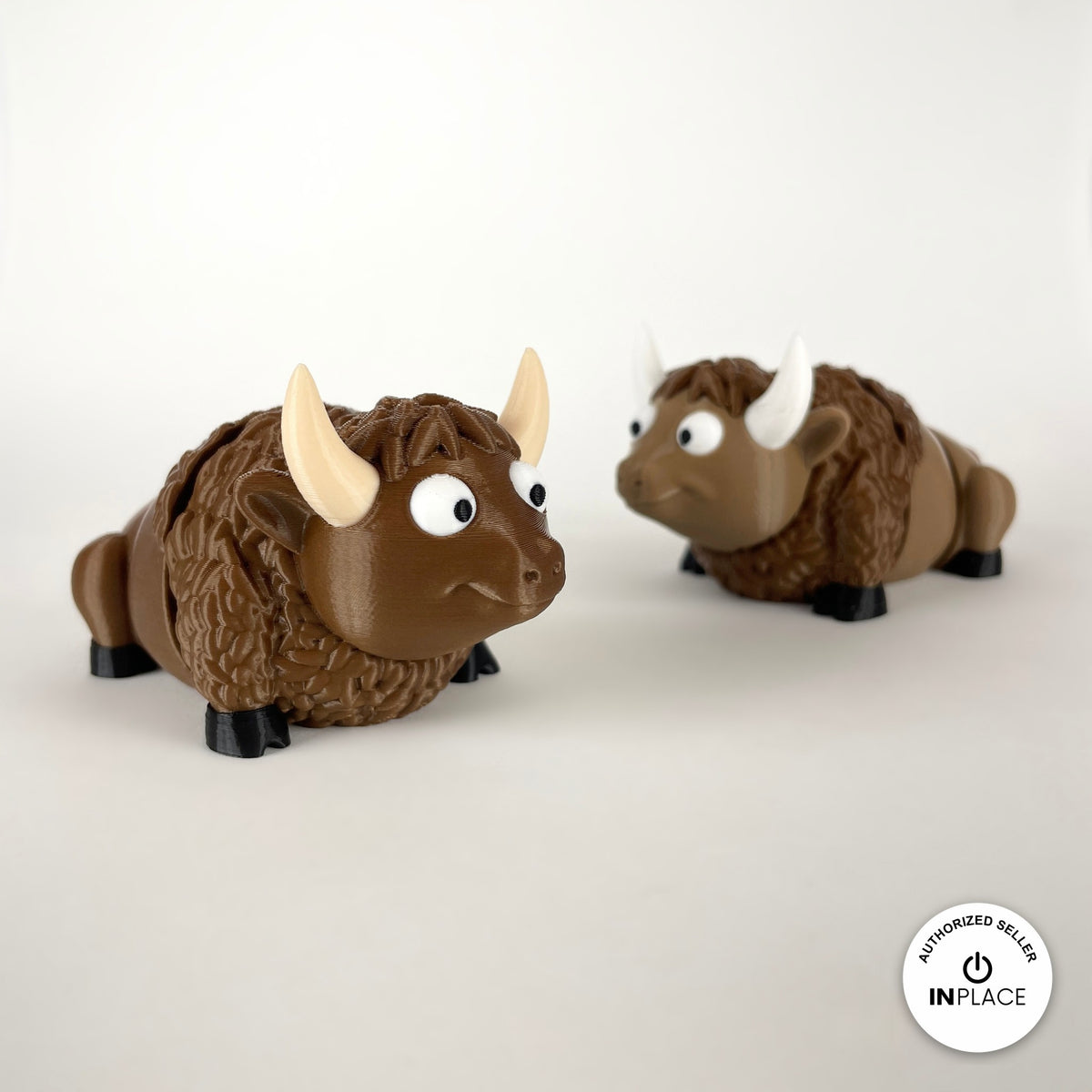 Cute bison keychain, 3D printed by RU3D – pair of bison. Brown with cream horns and black hooves.