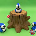 Cute blue jay keychain, 3D printed by RU3D – on tree stump box front view. Blue, white and black bird with tree stump box.