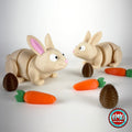 Cute bunny rabbit keychain, 3D printed by RU3D – pair of bunnies with carrots and eggs. Cream with pink ears and orange carrots.