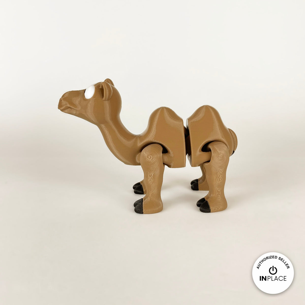 Cute camel keychain, 3D printed by RU3D – side view facing left. Tan brown with black hooves.
