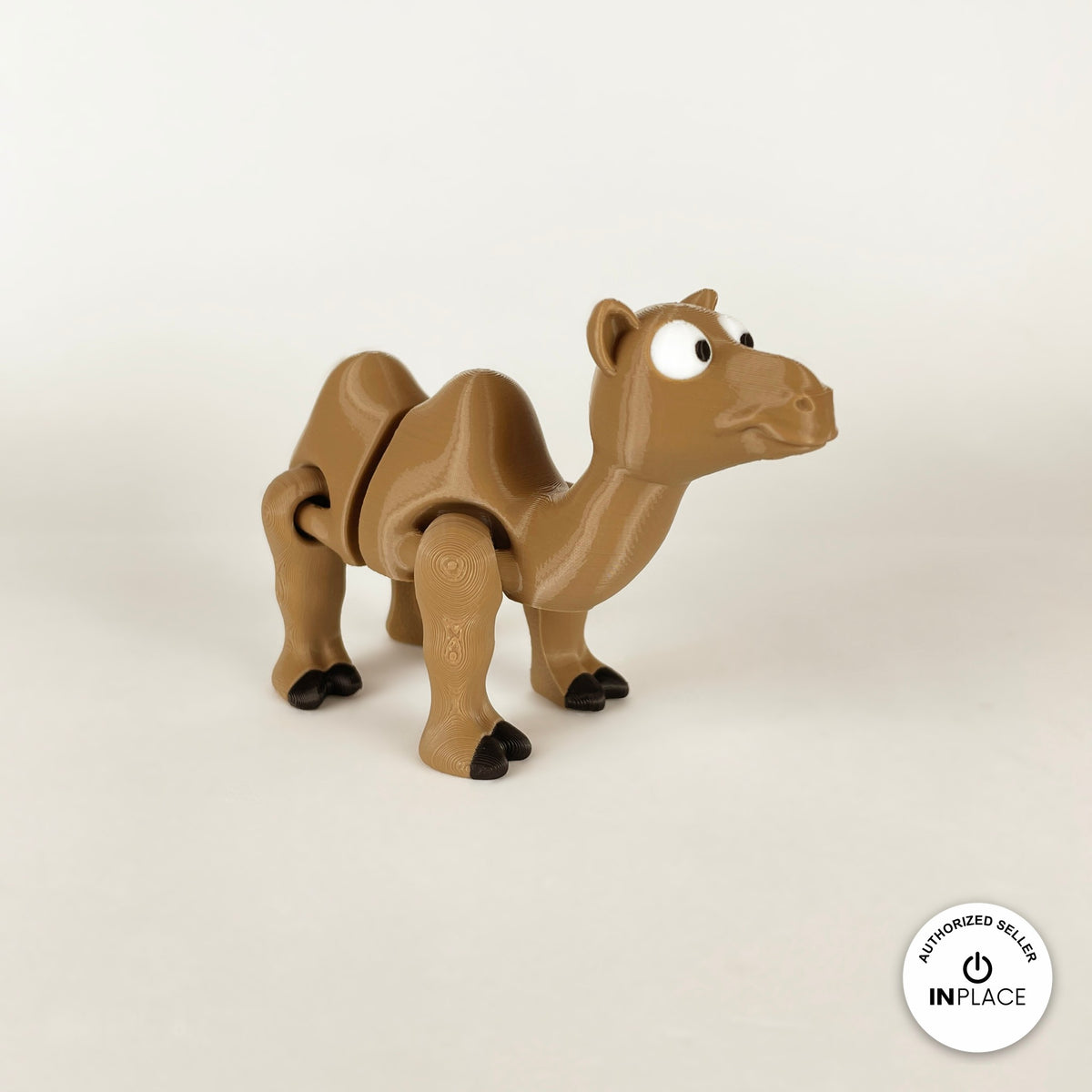 Cute camel keychain, 3D printed by RU3D – three quarter view facing right. Tan brown with black hooves.