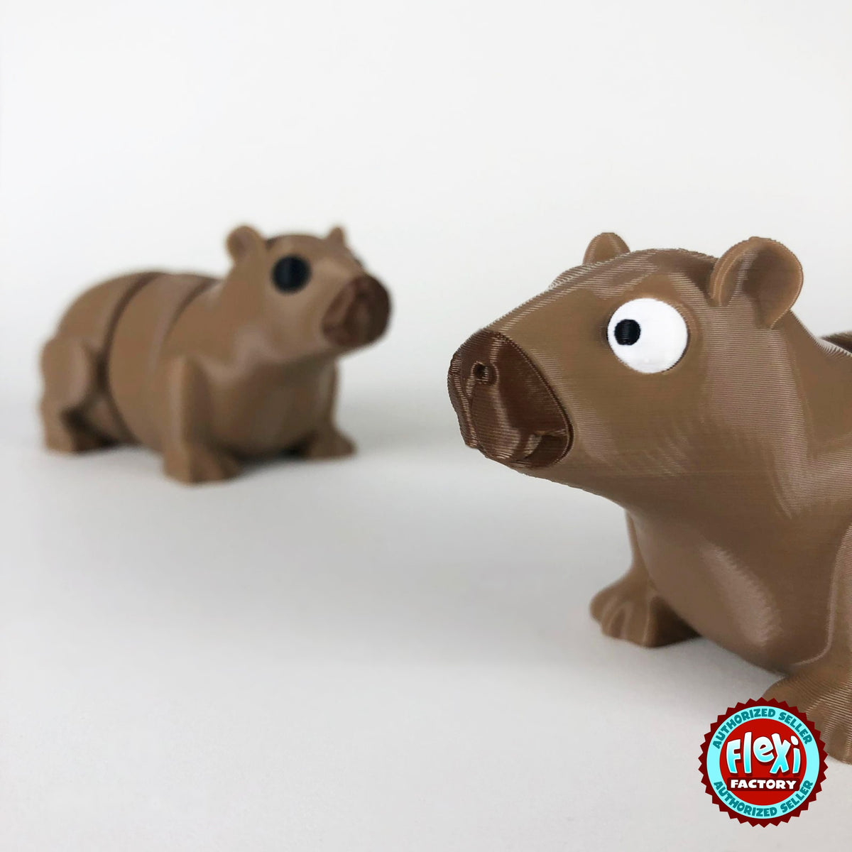 Cute capybara keychain, 3D printed by RU3D – close up face with capybara behind. Light brown.