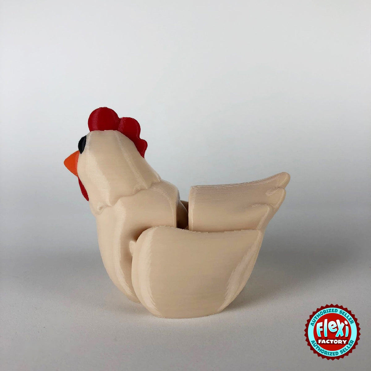 Cute chicken keychain, 3D printed by RU3D – cream hen dark eyes facing left. White hen with red comb and orange beak, also in cream.