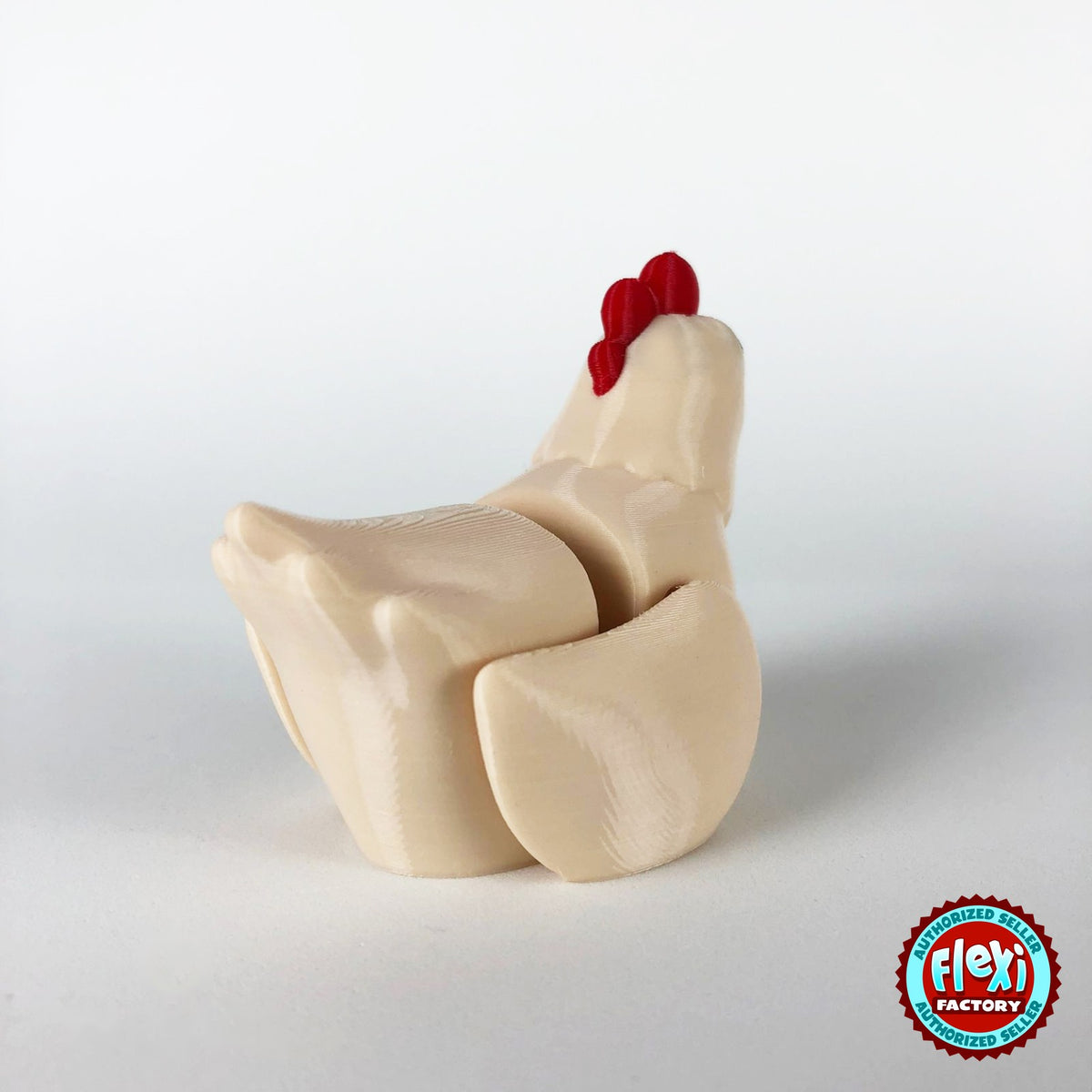 Cute chicken keychain, 3D printed by RU3D – cream hen dark eyes rear three quarter view. White hen with red comb and orange beak, also in cream.