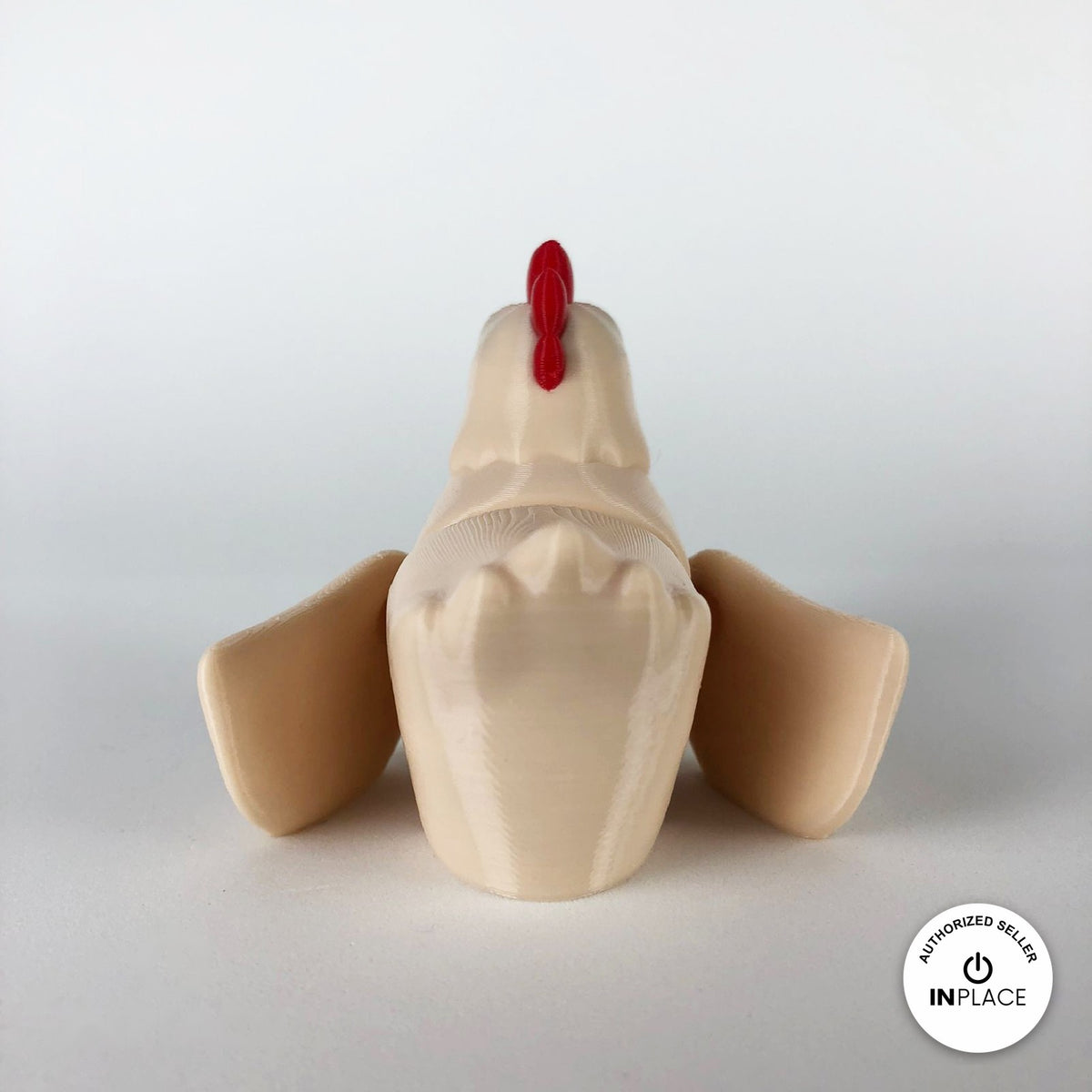 Cute chicken keychain, 3D printed by RU3D – cream hen rear view wings out. White hen with red comb and orange beak, also in cream.