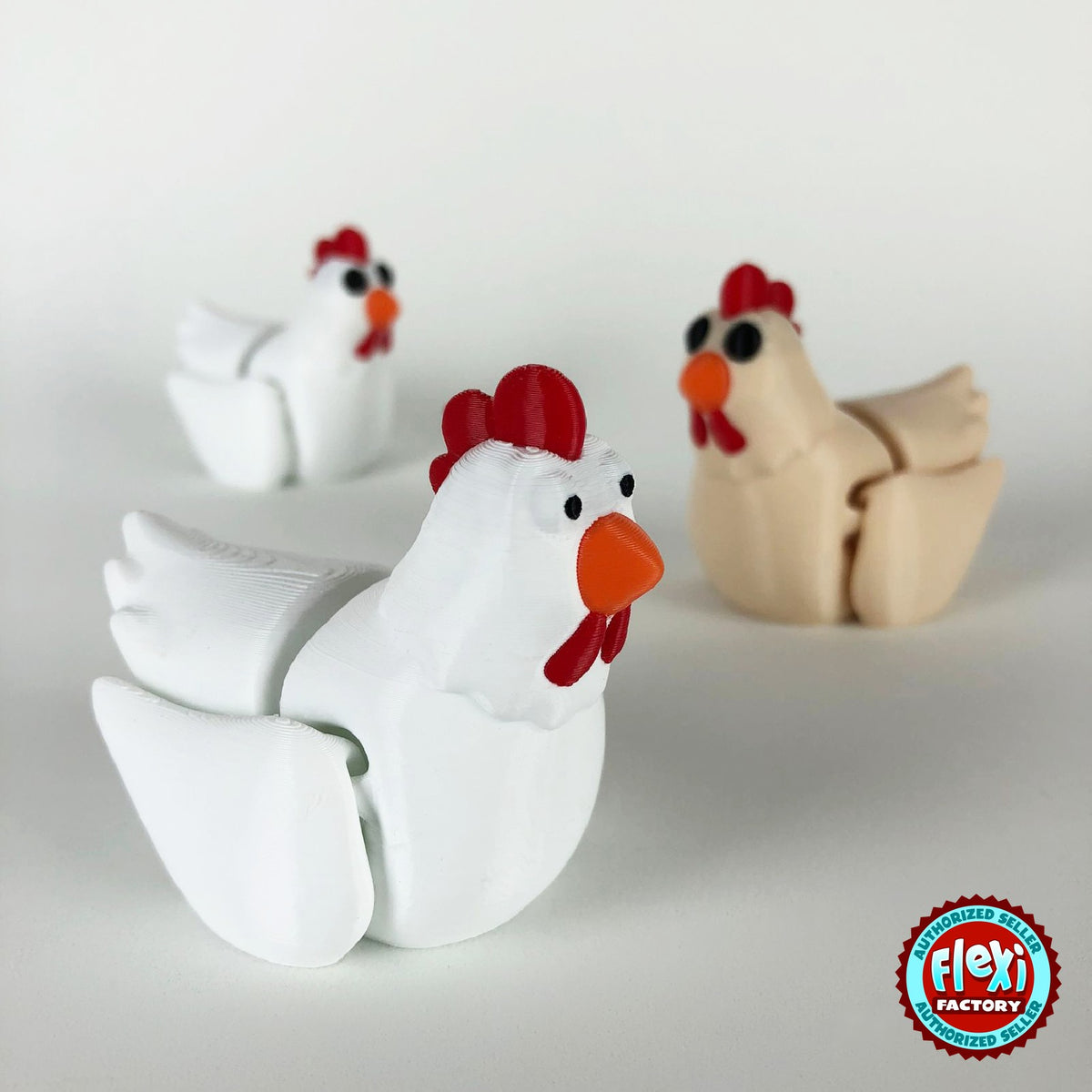 Cute chicken keychain, 3D printed by RU3D – group of hens. White hen with red comb and orange beak, also in cream.