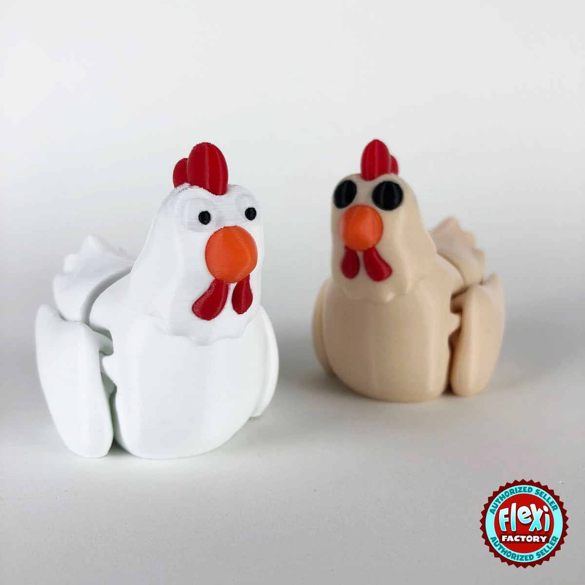 Cute chicken keychain, 3D printed by RU3D – white and cream hens together. White hen with red comb and orange beak, also in cream.