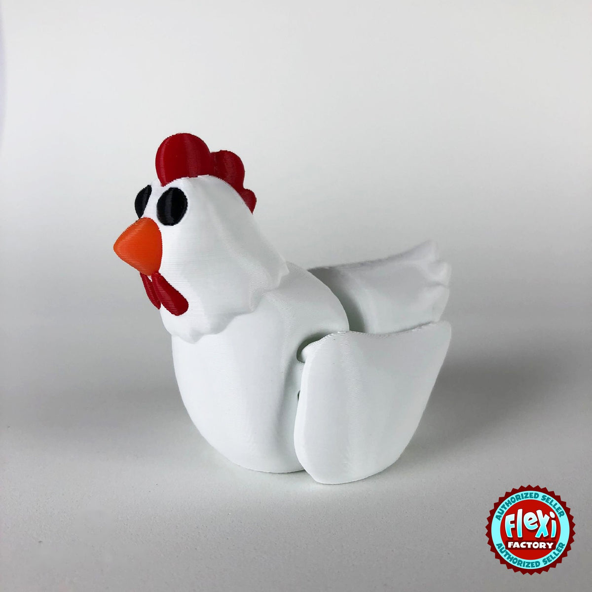 Cute chicken keychain, 3D printed by RU3D – white hen dark eyes facing left. White hen with red comb and orange beak, also in cream.