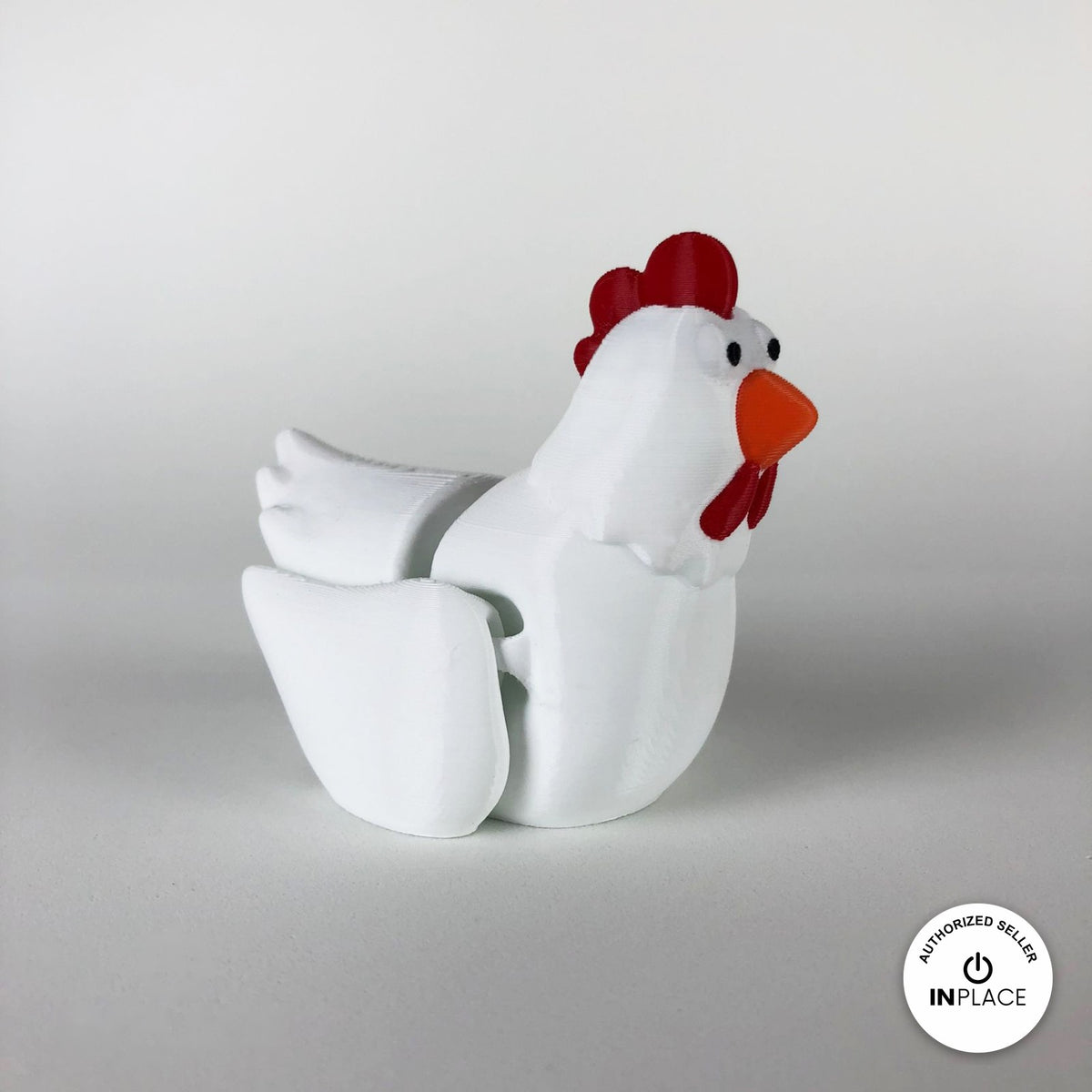 Cute chicken keychain, 3D printed by RU3D – white hen three quarter view facing right. White hen with red comb and orange beak, also in cream.