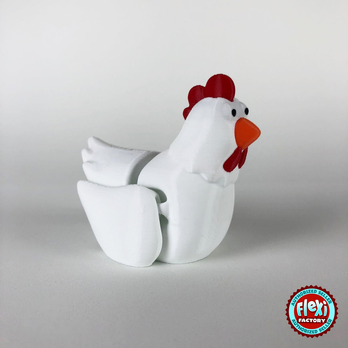 Cute chicken keychain, 3D printed by RU3D – white hen three quarter view facing right. White hen with red comb and orange beak, also in cream.