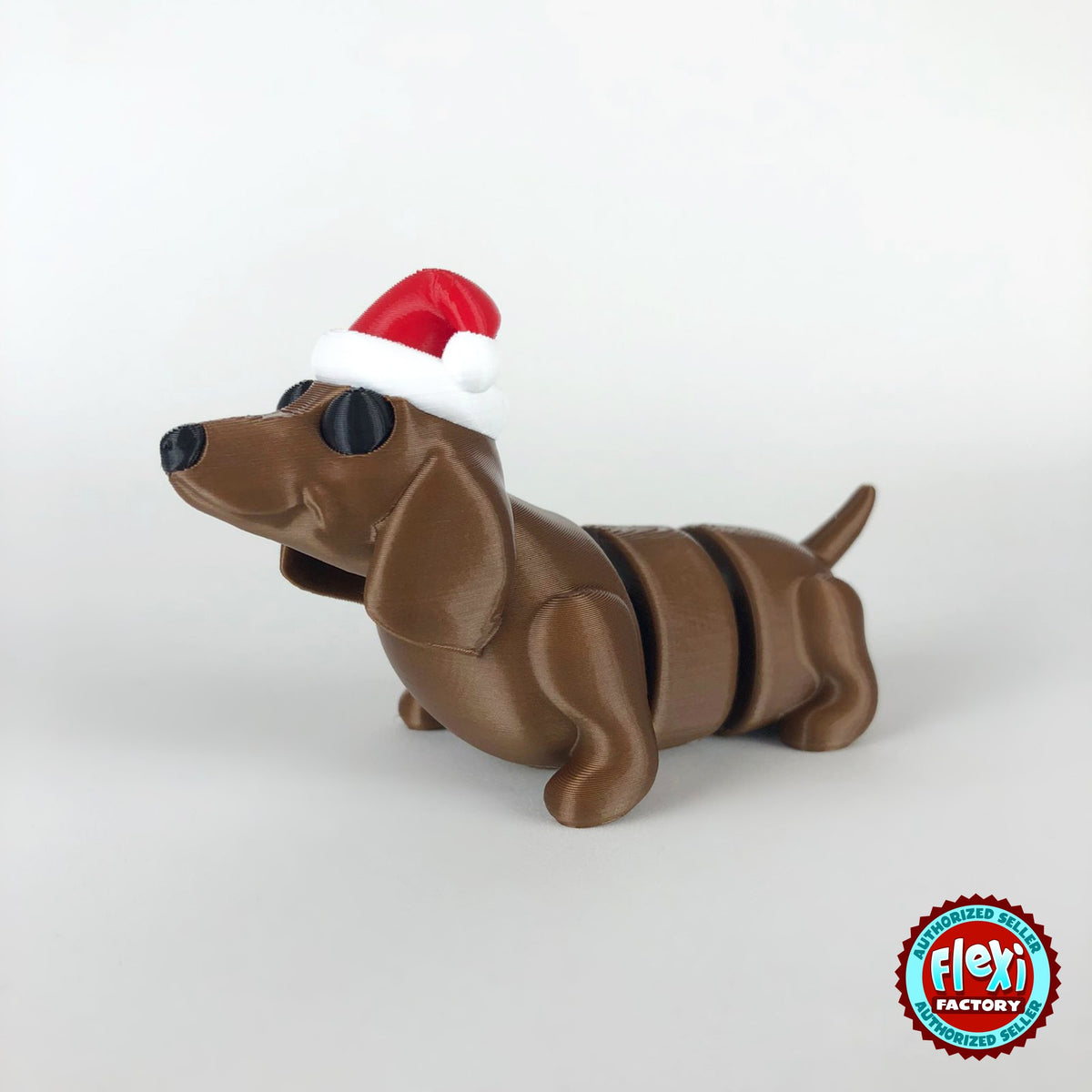 Cute Christmas dachshund keychain, 3D printed by RU3D – dark eyes three quarter view facing left. Brown sausage dog with red Santa hat.