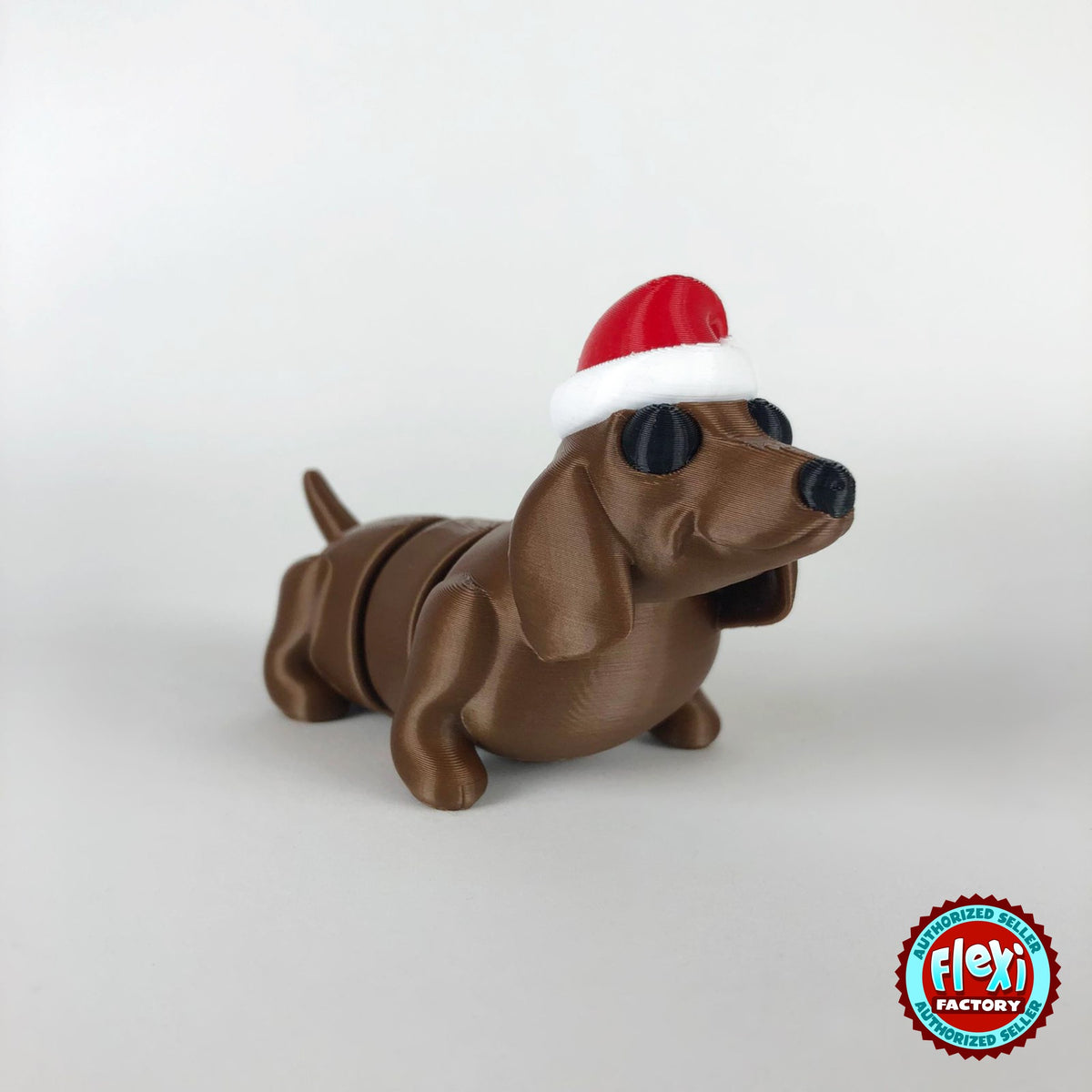 Cute Christmas dachshund keychain, 3D printed by RU3D – dark eyes three quarter view facing right. Brown sausage dog with red Santa hat.