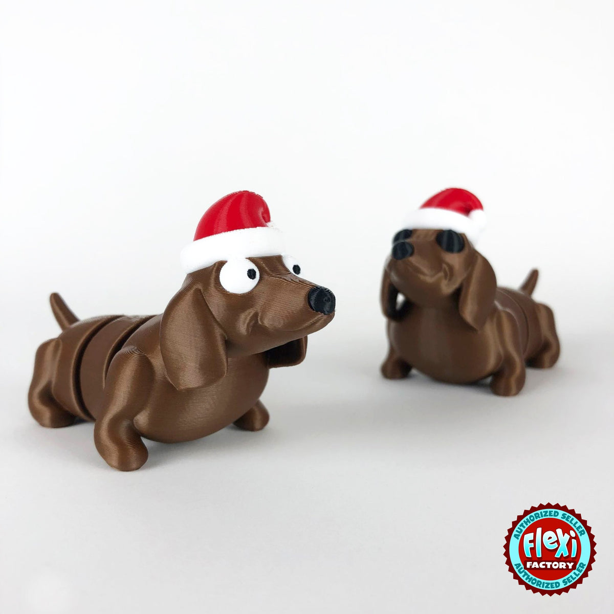 Cute Christmas dachshund keychain, 3D printed by RU3D – pair of Christmas dachshunds. Brown sausage dog with red Santa hat.