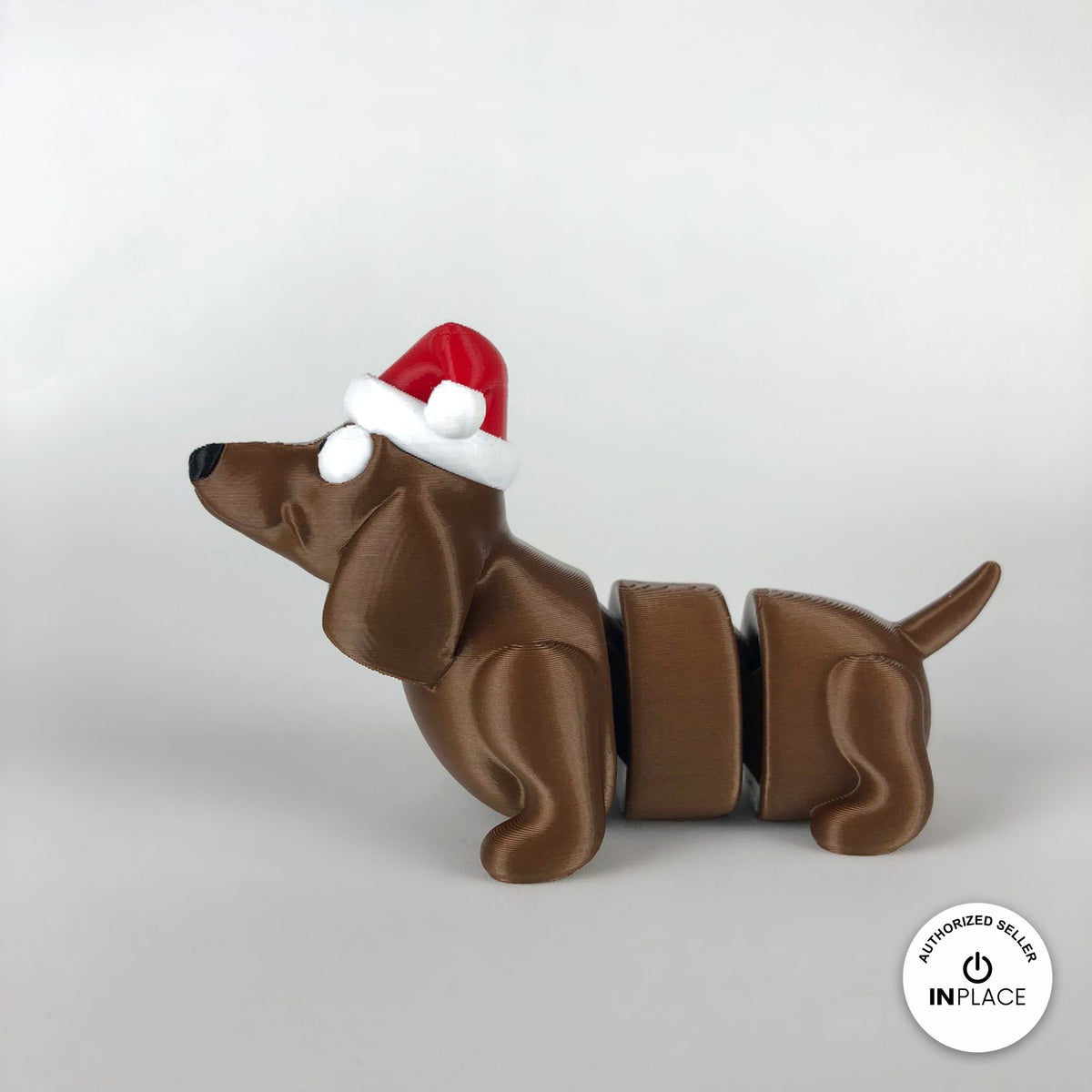 Cute Christmas dachshund keychain, 3D printed by RU3D – side view facing left. Brown sausage dog with red Santa hat.