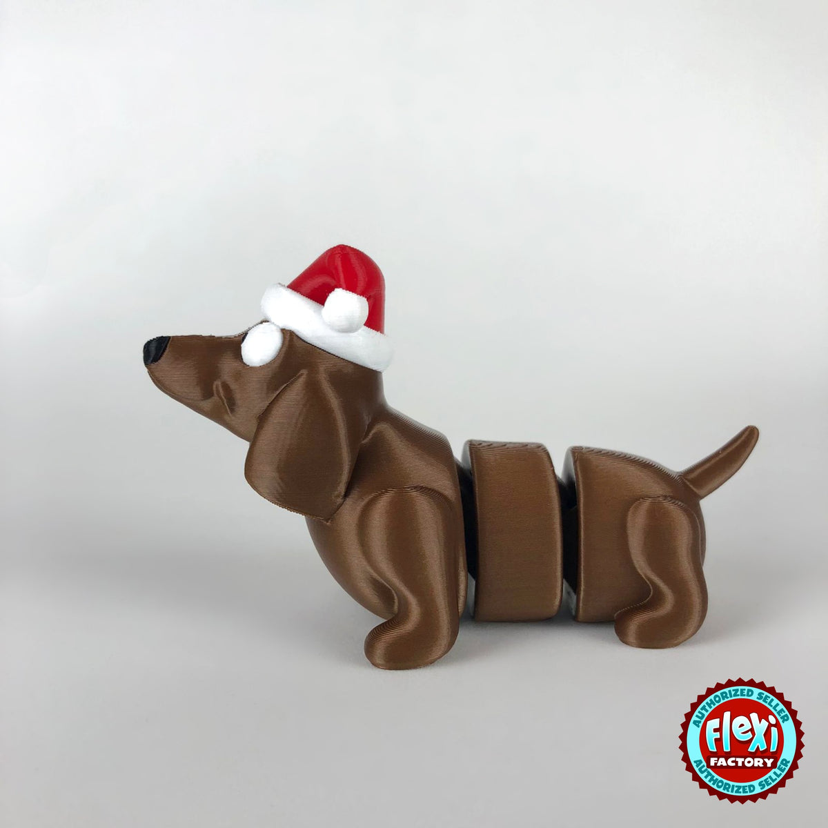 Cute Christmas dachshund keychain, 3D printed by RU3D – side view facing left. Brown sausage dog with red Santa hat.