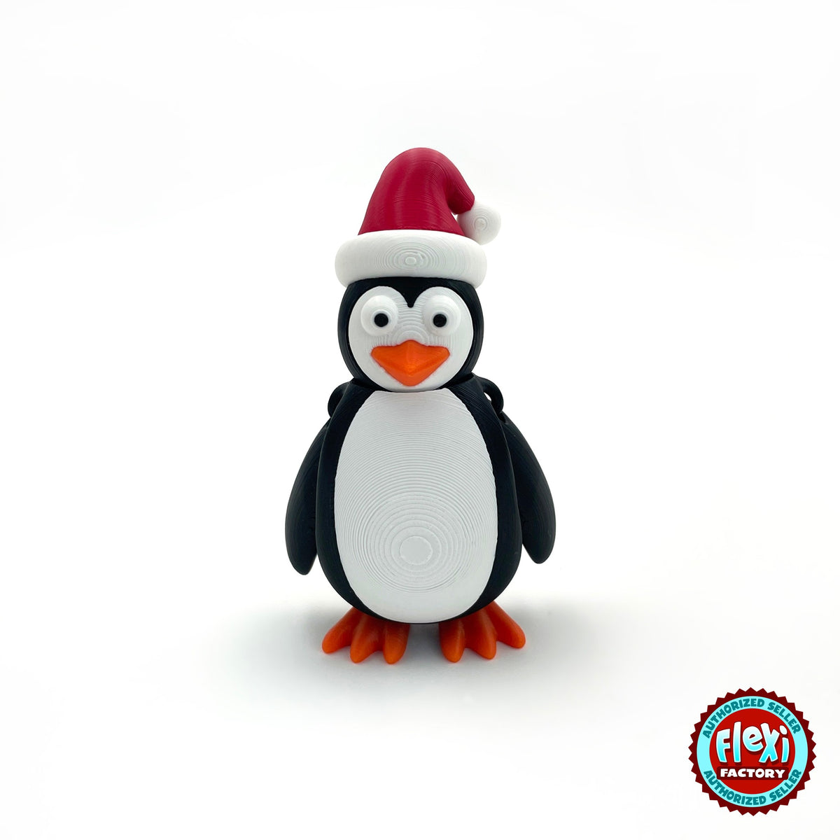 Cute Christmas penguin keychain, 3D printed by RU3D – front view. Black and white with red Santa hat and orange feet.