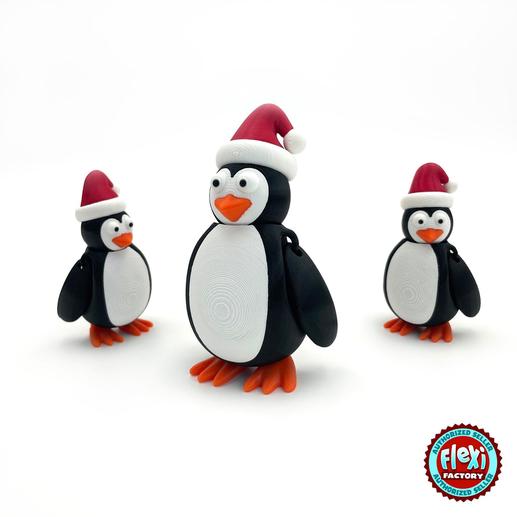 Cute Christmas penguin keychain, 3D printed by RU3D – group of Christmas penguins. Black and white with red Santa hat and orange feet.