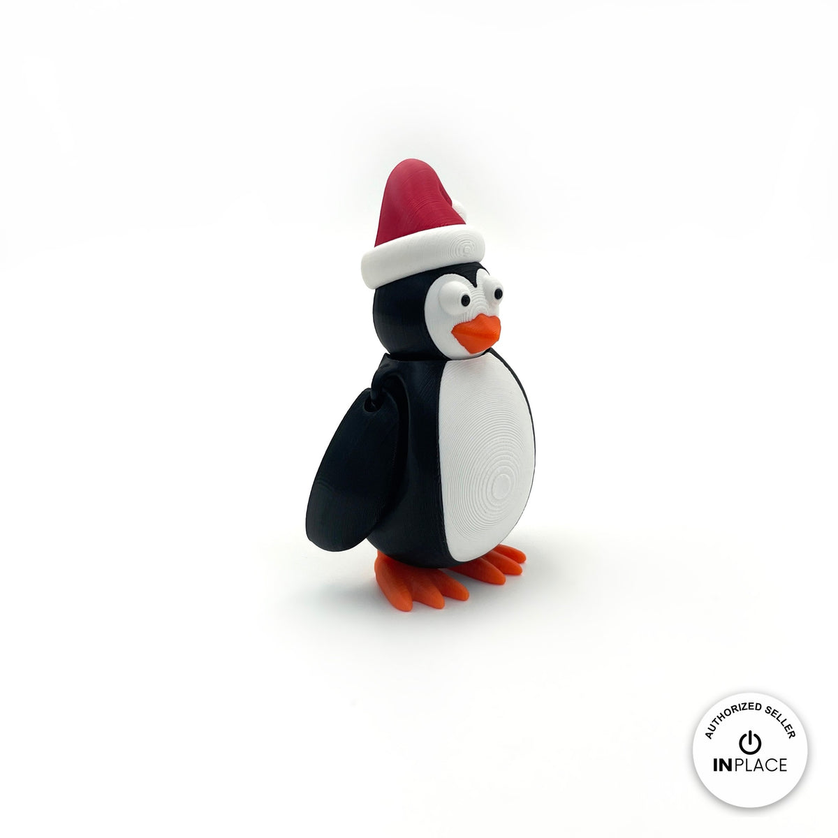 Cute Christmas penguin keychain, 3D printed by RU3D – side view facing right. Black and white with red Santa hat and orange feet.