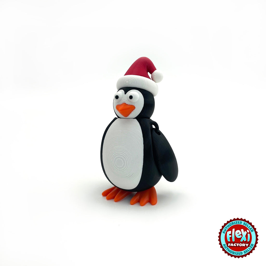 Cute Christmas penguin keychain, 3D printed by RU3D – three quarter view facing left. Black and white with red Santa hat and orange feet.