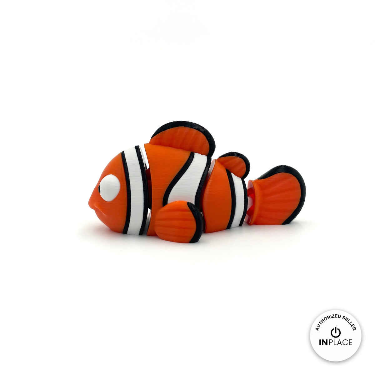 Cute clownfish keychain, 3D printed by RU3D – side view facing left. Orange with white and black stripes.