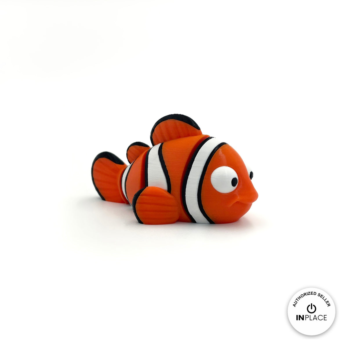 Cute clownfish keychain, 3D printed by RU3D – three quarter view facing right. Orange with white and black stripes.