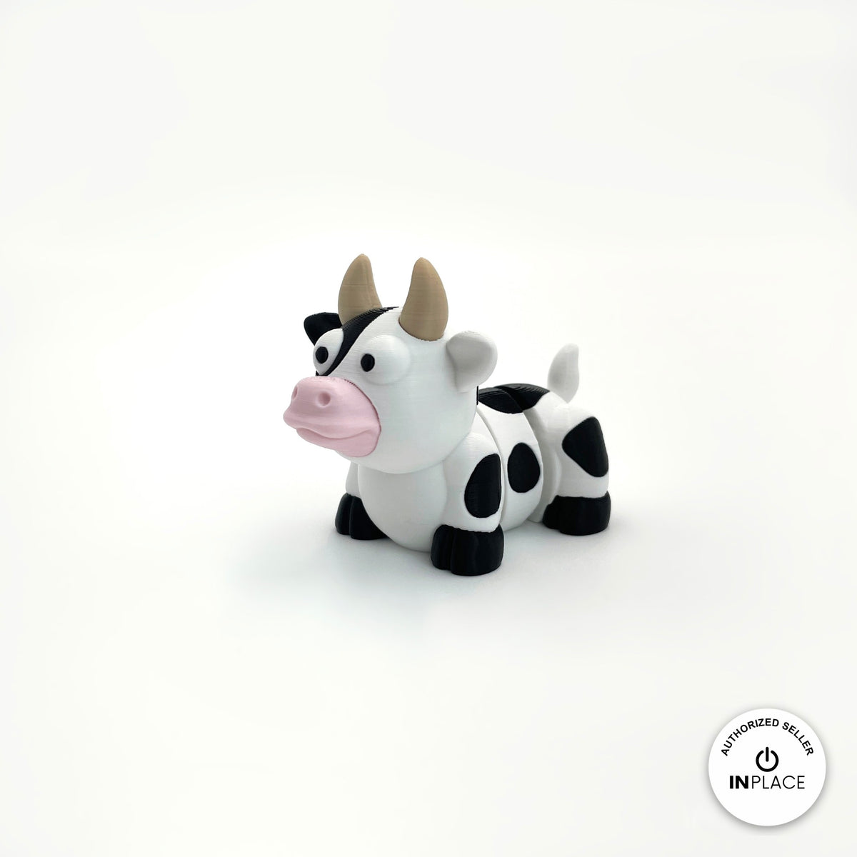 Cute cow keychain, 3D printed by RU3D – three quarter view facing left. Black and white dairy cow with pink nose.
