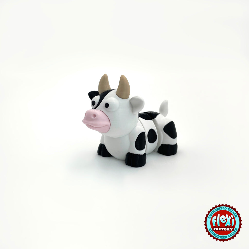 Cute cow keychain, 3D printed by RU3D – three quarter view facing left. Black and white dairy cow with pink nose.