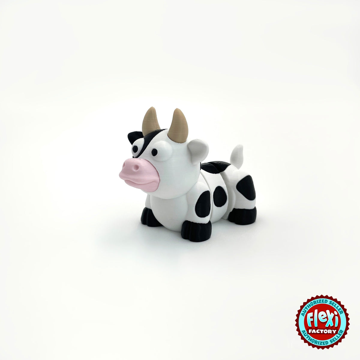 Cute cow keychain, 3D printed by RU3D – three quarter view facing left. Black and white dairy cow with pink nose.