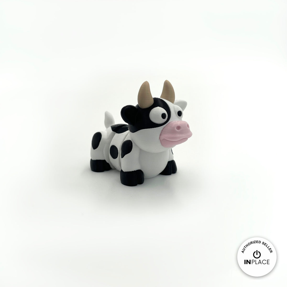 Cute cow keychain, 3D printed by RU3D – three quarter view facing right. Black and white dairy cow with pink nose.