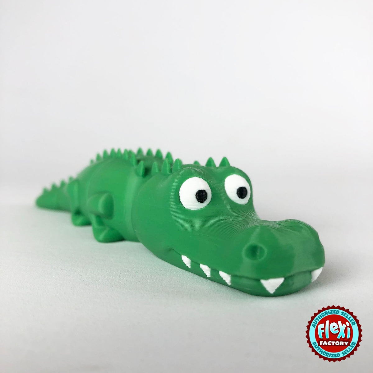 Cute crocodile keychain, 3D printed by RU3D – close up three quarter view. Green with white teeth.
