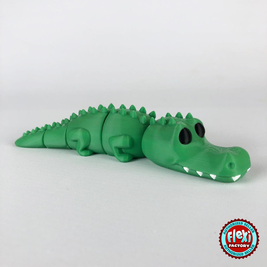 Cute crocodile keychain, 3D printed by RU3D – dark eyes side view facing right. Green with white teeth.