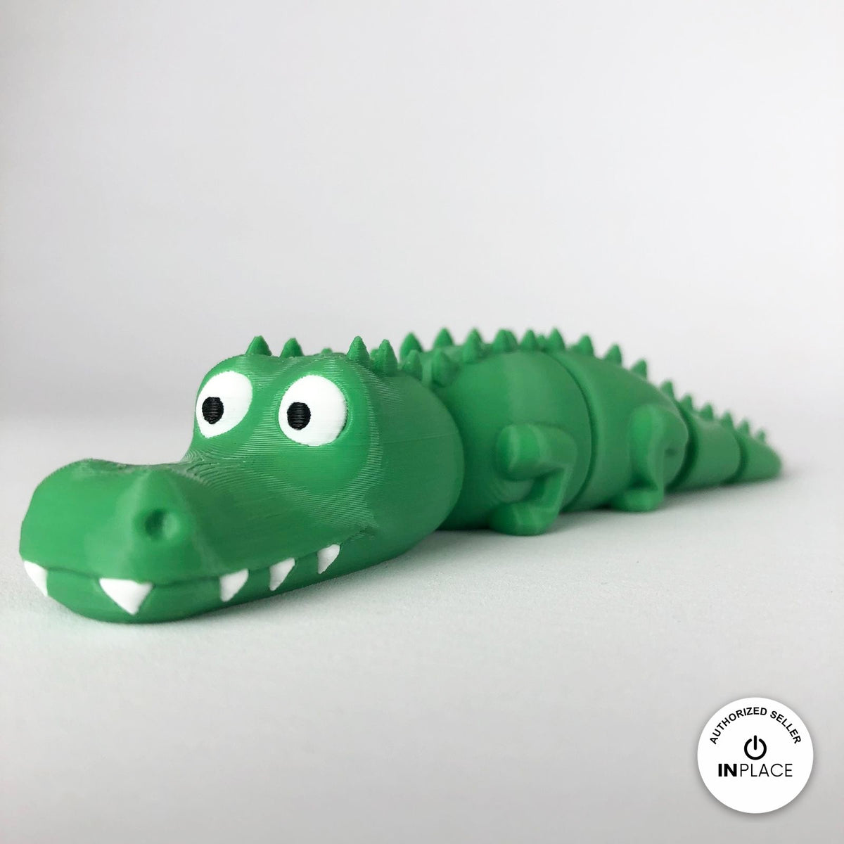 Cute crocodile keychain, 3D printed by RU3D – front three quarter view facing left. Green with white teeth.