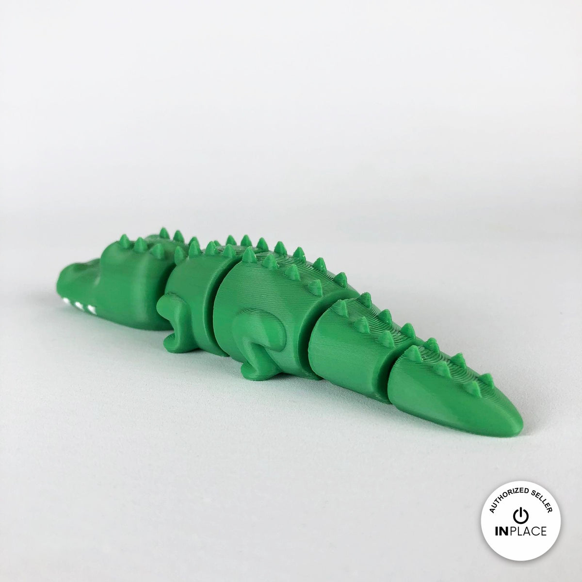 Cute crocodile keychain, 3D printed by RU3D – rear three quarter view. Green with white teeth.