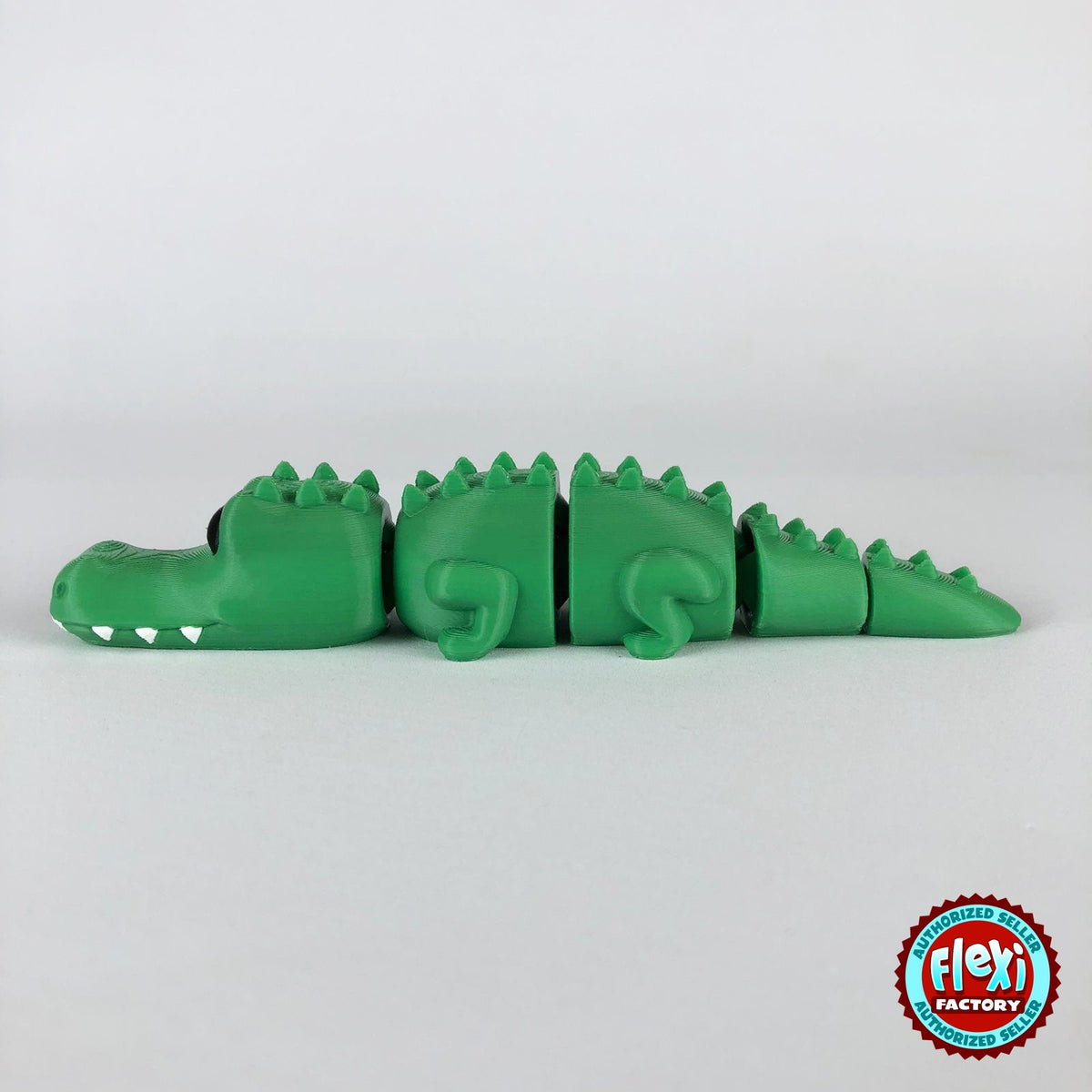 Cute crocodile keychain, 3D printed by RU3D – side view facing left. Green with white teeth.