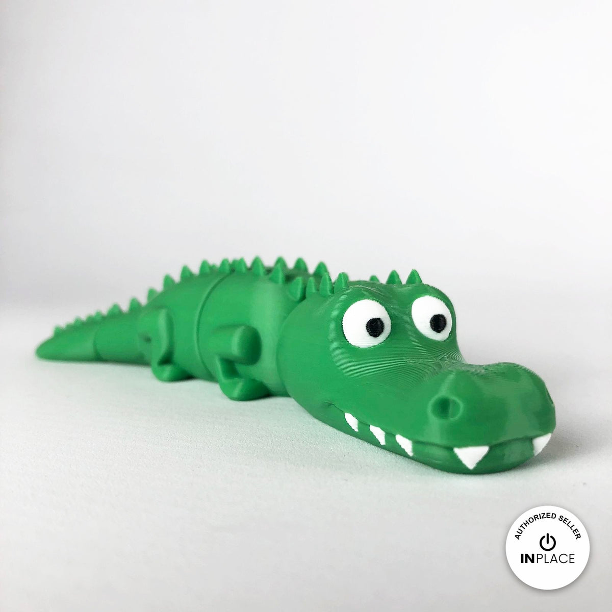Cute crocodile keychain, 3D printed by RU3D – three quarter view facing right. Green with white teeth.