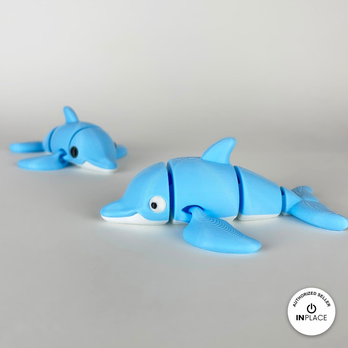 Cute dolphin keychain, 3D printed by RU3D – pair of dolphins swimming left. Sky blue with white belly.
