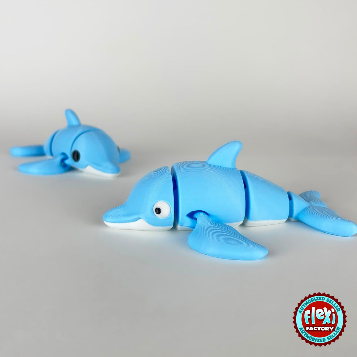 Cute dolphin keychain, 3D printed by RU3D – pair of dolphins swimming left. Sky blue with white belly.